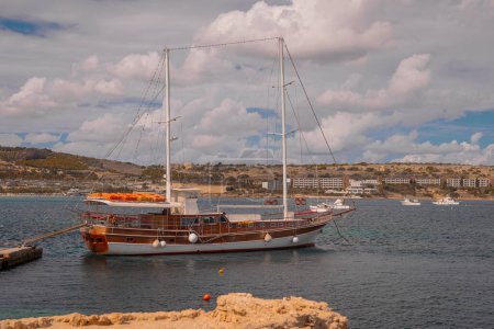 Photo for A big ketch type sailboat moored in the harbor of Ghadira, Malta. Visible both masts, front bigger main mast and the rear smaller mizzen mast. - Royalty Free Image