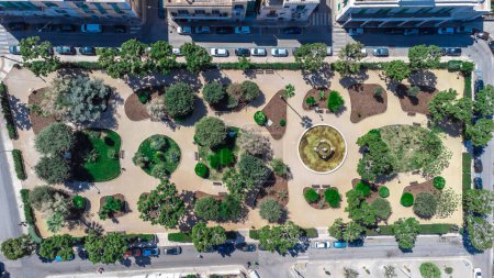 Fontanelle park in the centre of Monopoli, a beautiful italian coastal town in the region of Puglia. Direct above view of a park and parked cars around