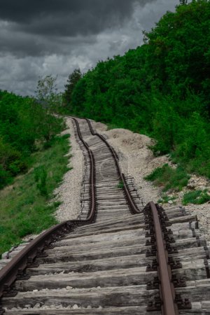 Pijana pruga or drunk railway in Istria, Croatia. A stretch of neglected railway track and bed, deformed rails, washed down by land slide or poor earth base