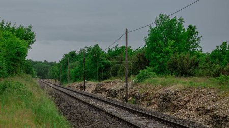 Empty stretch of straight railway track leading towards pula, croatia close to station of Vodnjan. Curve seen in the background