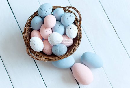 Foto de Basket with Easter eggs. Easter egg hunt . selective focus, copy space - Imagen libre de derechos