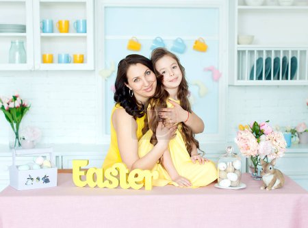 Photo for Mother and daughter together at home Easter celebration sitting looking camera - Royalty Free Image