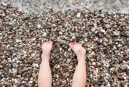 Photo for Summer vacation, sunbathing and pedicure concept -child lying on the beach - Royalty Free Image