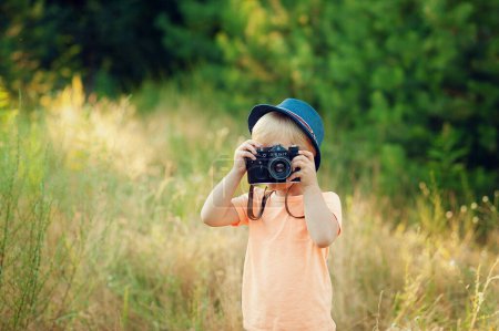Photo for Child with camera. Photographer. taking photos - Royalty Free Image
