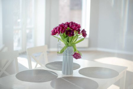 Photo for Home interior dcor, bouquet of flowers in vase on table in the kitchen - Royalty Free Image