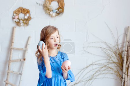 Photo for Portrait of lovely, cheerful blond girl , holding colored eggs, celebrating Easter with family - Royalty Free Image