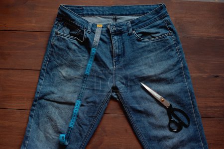 Photo for Denim Upcycling Ideas, Using Old Jeans, Repurposing Jeans, Reusing Old Jeans, Upcycle Stuff. Stack of old blue jeans and sewing tools - Royalty Free Image