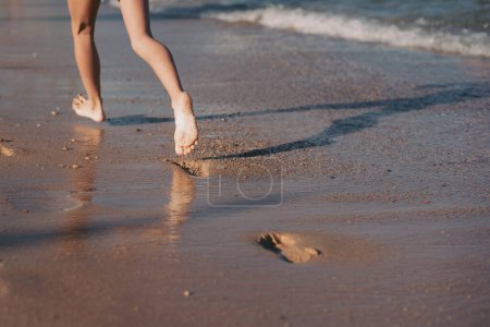 Photo for Female feet step on the sea wave. Summer vacations concept - Royalty Free Image