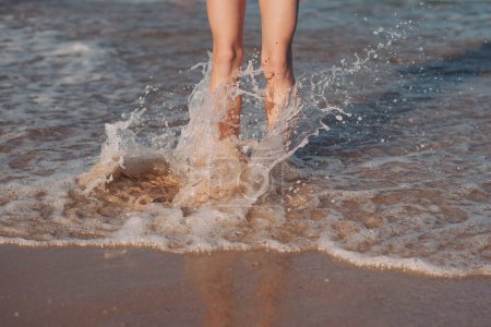 Photo for Female feet step on the sea wave. Summer vacations concept - Royalty Free Image