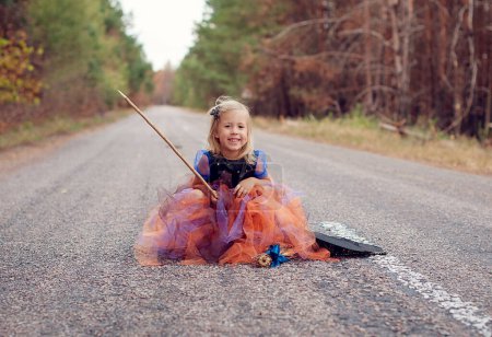 Photo for Funny child girl in witch costume for Halloween - Royalty Free Image