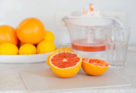 Photo for Juice extractor or juicer preparing to make grapefruit juice - Royalty Free Image