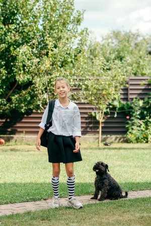 Photo for Back to school. Cute child girl with backpack going to school with fun - Royalty Free Image