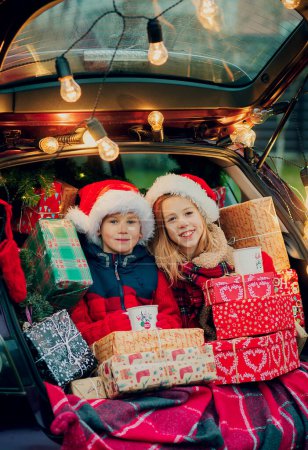 Photo for Merry Christmas. children with Christmas gifts outdoors - Royalty Free Image