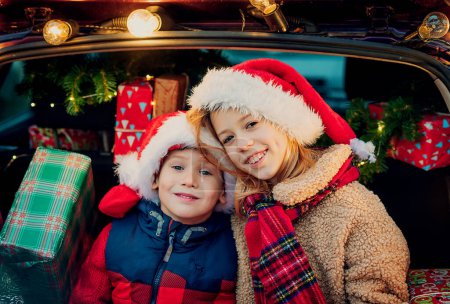 Photo for Merry Christmas. happy kids with Christmas gifts outdoors - Royalty Free Image