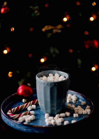 Photo for Christmas cup of cocoa with marshmallows against the background of a Christmas tree. New Year's mood - Royalty Free Image