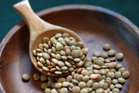 Photo for Lentils served on a round wooden plate - Royalty Free Image