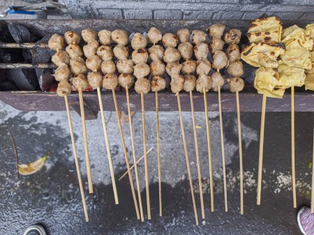 Foto de Albóndigas a la parrilla. comida tradicional local callejera en indonesia donde el proceso de fabricación se asan a la parrilla en carbón caliente - Imagen libre de derechos