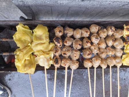 Photo for Grilled meatballs. traditional street local food in indonesia where the manufacturing process is grilled on hot charcoal - Royalty Free Image