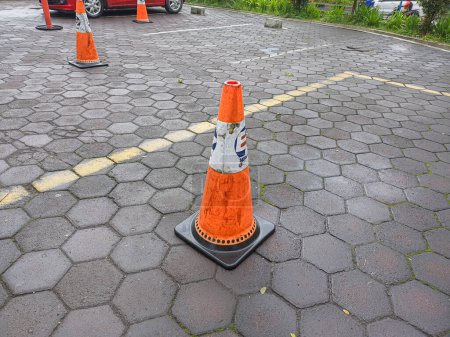 Photo for Red safety cone in the parking lot outside the mall - Royalty Free Image
