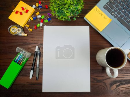 Photo for Flat lay, mock up paper. workspace in the background of the office desk from the top view. A workspace with blank white paper, laptops, office supplies, pencils, green leaves, and coffee cups against the backdrop of a wooden table. - Royalty Free Image