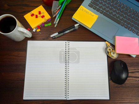Photo for Flat lay, a mock up of a notebook. workspace in the background of the office desk from the top view. A workspace with white notebooks, laptops, office supplies, pencils, and coffee cups in the background of a wooden desk. - Royalty Free Image