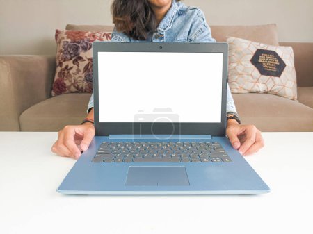 Photo for Mockup laptop. asian woman showing new model laptop to recommend buying advice in casual jean jacket on white table - Royalty Free Image