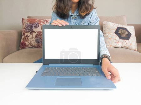 Photo for Mockup laptop. asian woman showing new model laptop to recommend buying advice in casual jean jacket on white table - Royalty Free Image