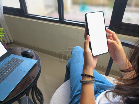 Photo for Computer, blank screen phone mockup image with white background for advertising, woman's hand using laptop and mobile phone on table in cafe.mockup - Royalty Free Image