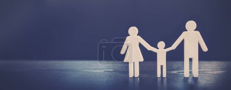Figurine of the family on the black background. Abstract background.