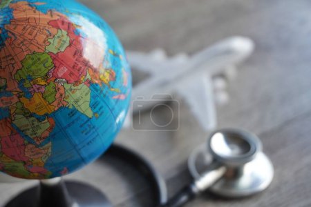 Photo for Selective focus image of globe, toy plane and stethoscope. Medical tourism concept - Royalty Free Image