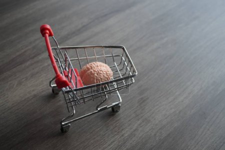 Photo for A human brain inside shopping carts. Consumer behavior, impulse buying and shopping addiction concept. - Royalty Free Image