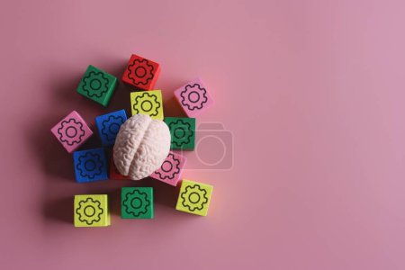 Photo for Closeup image of brain and wooden cubes with mechanical gear icon. Copy space for text. Thinking, brainstorming concept. - Royalty Free Image