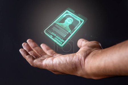 Photo for Closeup image of hand and digital identification card or digital ID on black background. Technology concept. - Royalty Free Image