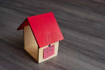 Photo for Closeup image of toy house and eviction notice. - Royalty Free Image