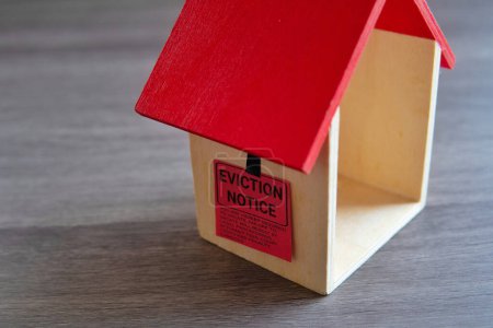 Photo for Closeup image of toy house and eviction notice. - Royalty Free Image