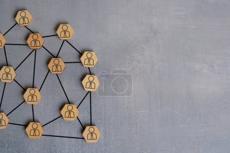 Photo for Wooden blocks connected with arrows. Each wooden block has a icon of a person. Networking concept. Copy space for text. - Royalty Free Image