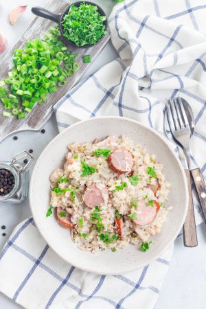 Chicken bog dish with smocked sausages, traditional South Carolina recipe, in a bowl, vertical, top view