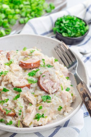 Chicken bog dish with smocked sausages, traditional South Carolina recipe, in a bowl, vertical