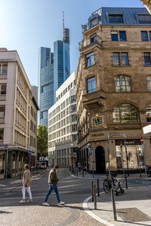 Photo for Frankfurt, Germany - 30th September 2022: Photographer visiting Frankfurt, exploring the pedestrian zone with the tall buildings in the background at a sunny day in autumn. - Royalty Free Image