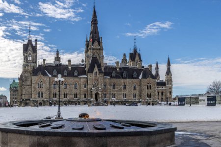 Téléchargez les photos : Ottawa, Canada - 08 février 2023 : Un photographe allemand découvre le parc Majors Hill au centre-ville d'Ottawa en vue des édifices historiques. - en image libre de droit