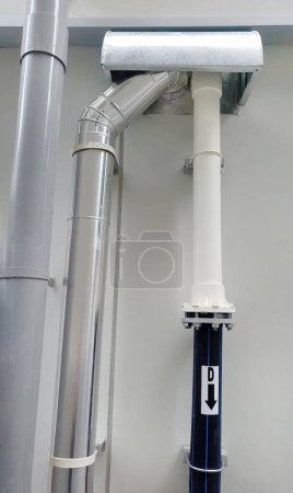 Photo for Down spout storm drain and other vertical pipeline with rain protection installed outside building, showing engineering sewage utility plumbing design system, flow direction - Royalty Free Image