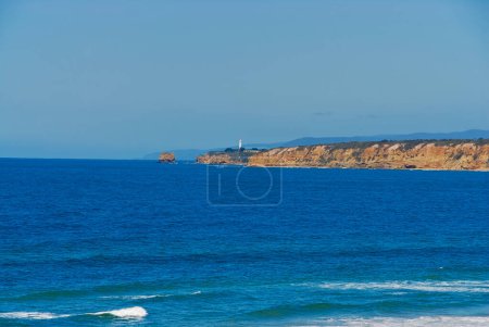 A view of a lighthouse on a clear sunny day along the Great Ocean Road in southern Victoria, Australia.