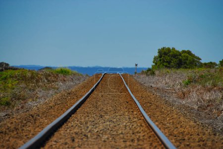 Railroad tracks seen distorted by heat haze on a hot day in the outback of Victoria, Australia.