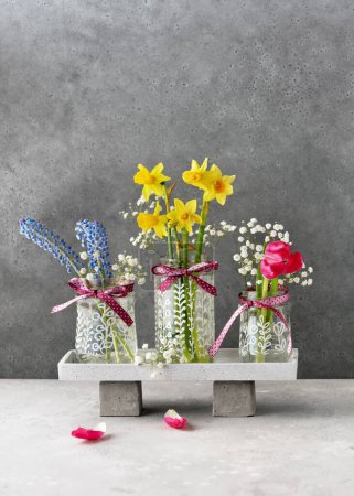 Photo for Three hand painted glass vases with different plants motifs and beautiful flower bouquets in it. Painting on glass jars, creativity with your own hands. Hobby for children. Copy space. - Royalty Free Image