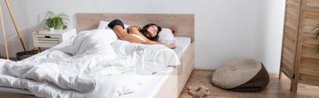Couple sleeping on white bedding at home, banner 