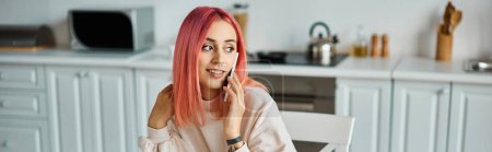 Photo for Cheerful attractive woman with vibrant pink hair talking by phone and looking away, banner - Royalty Free Image