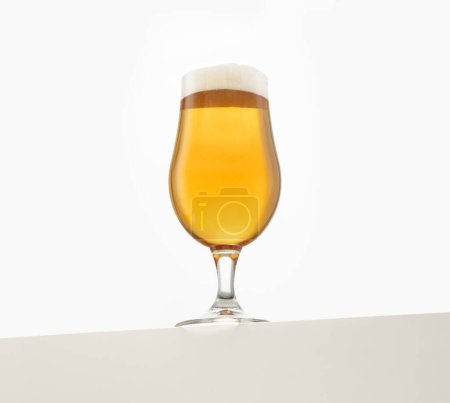 A full glass of amber beer with a frothy head, elegantly presented against a white background. The beer's rich golden hue and bubbles highlight its refreshing appeal, perfect for beverage advertising 