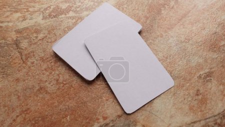 Foto de Playing cards modern mock up. Deck of playing card on a brown and beige marble surface.Blank white cards or business cards. Branding and holidays. - Imagen libre de derechos