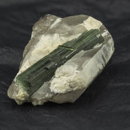 Photo for Green tourmaline mineral sample on matrix on black background - Royalty Free Image