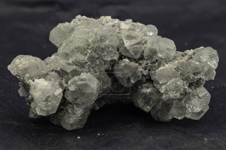 Cluster of translucent grey celestine crystals with natural rough matrix
